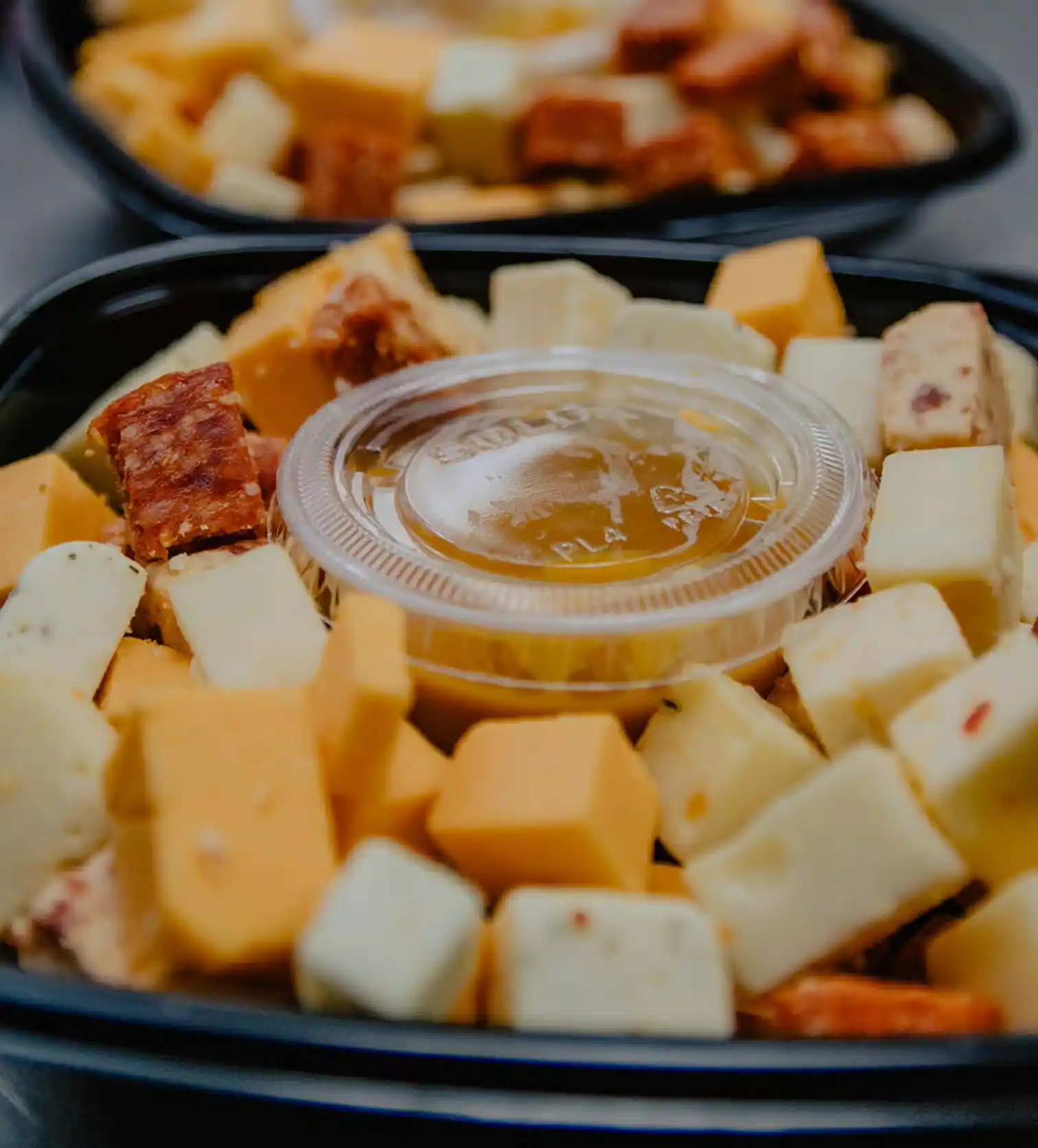 various cheese cubes arranged on a plastic tray