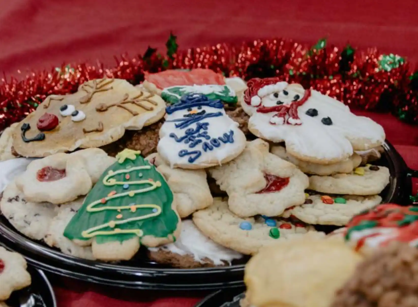 a tray of decorated cut out cookies